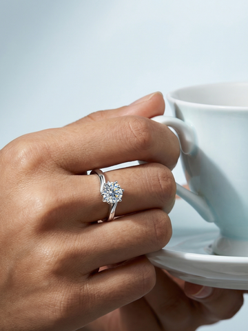 Silver Moissanite Swoop Ring by WryWry featuring a sparkling curved band with brilliant moissanite gemstones.